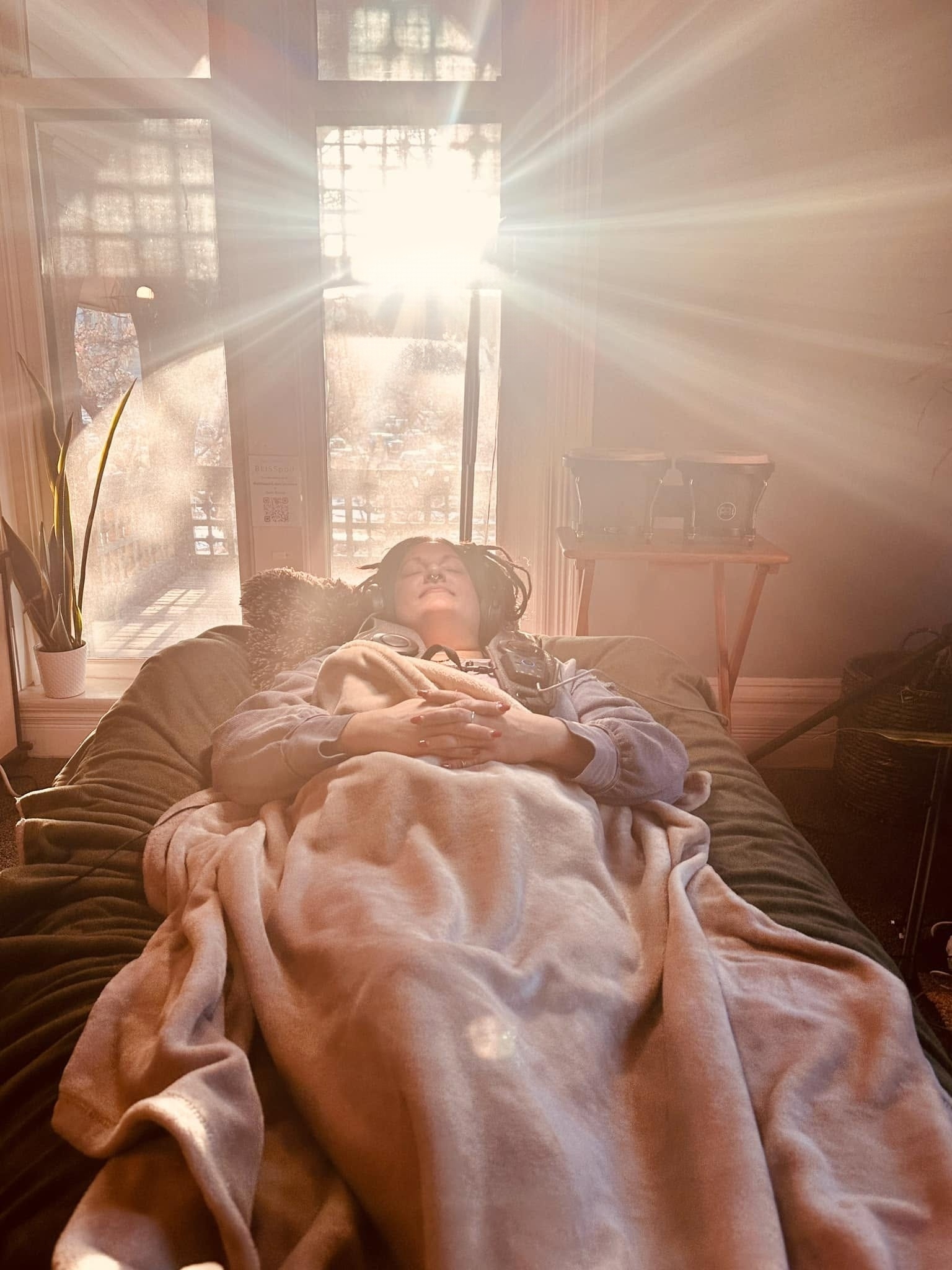 A guest resting in warm morning light during a session