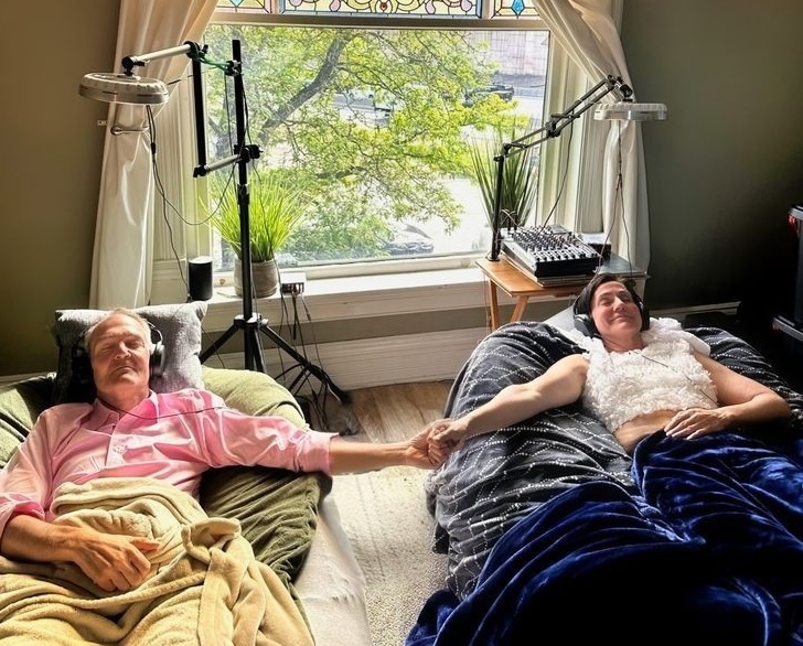 Two guests holding hands during a shared session