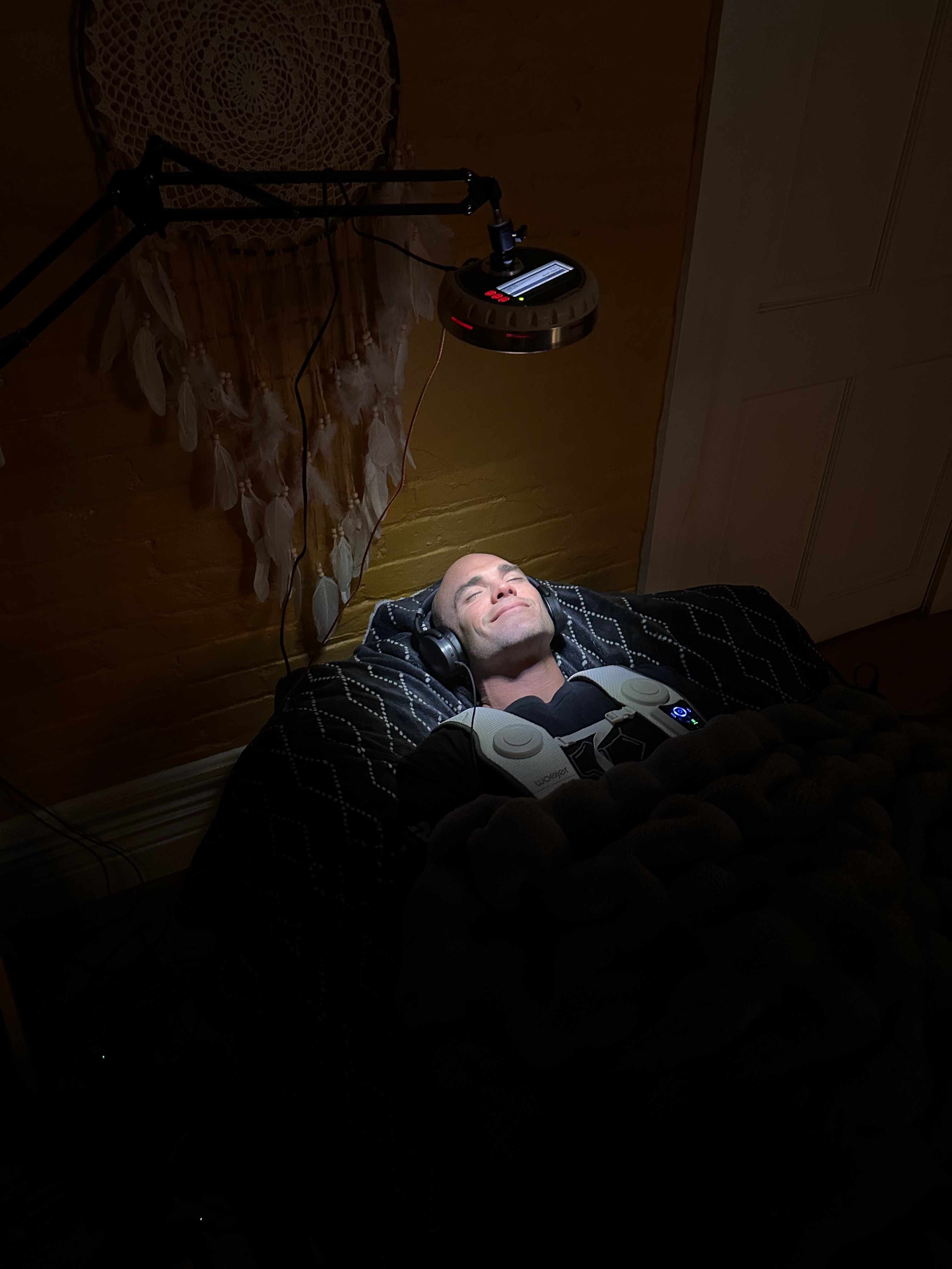 A guest resting beneath the light experience on the SomaBed