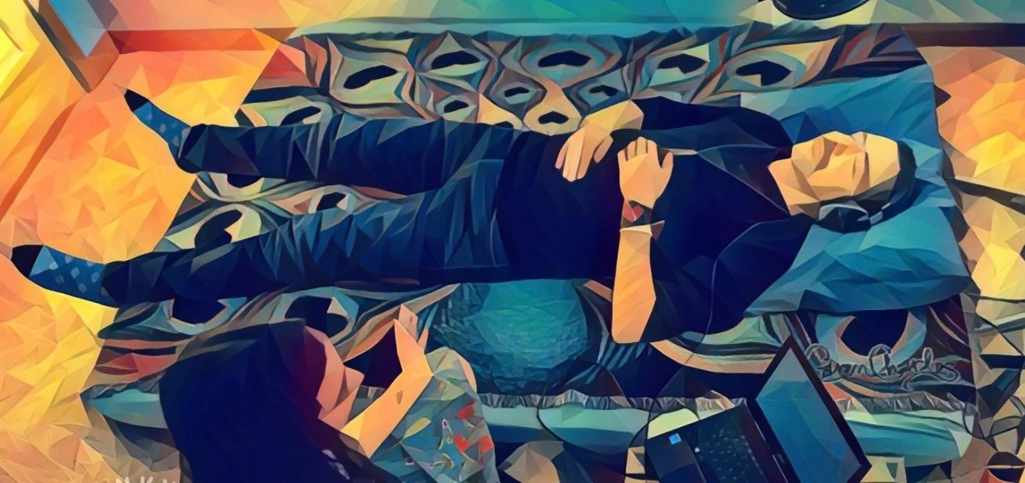A visitor resting under warm light during a nervous system regulation session at Denver Zen Den
