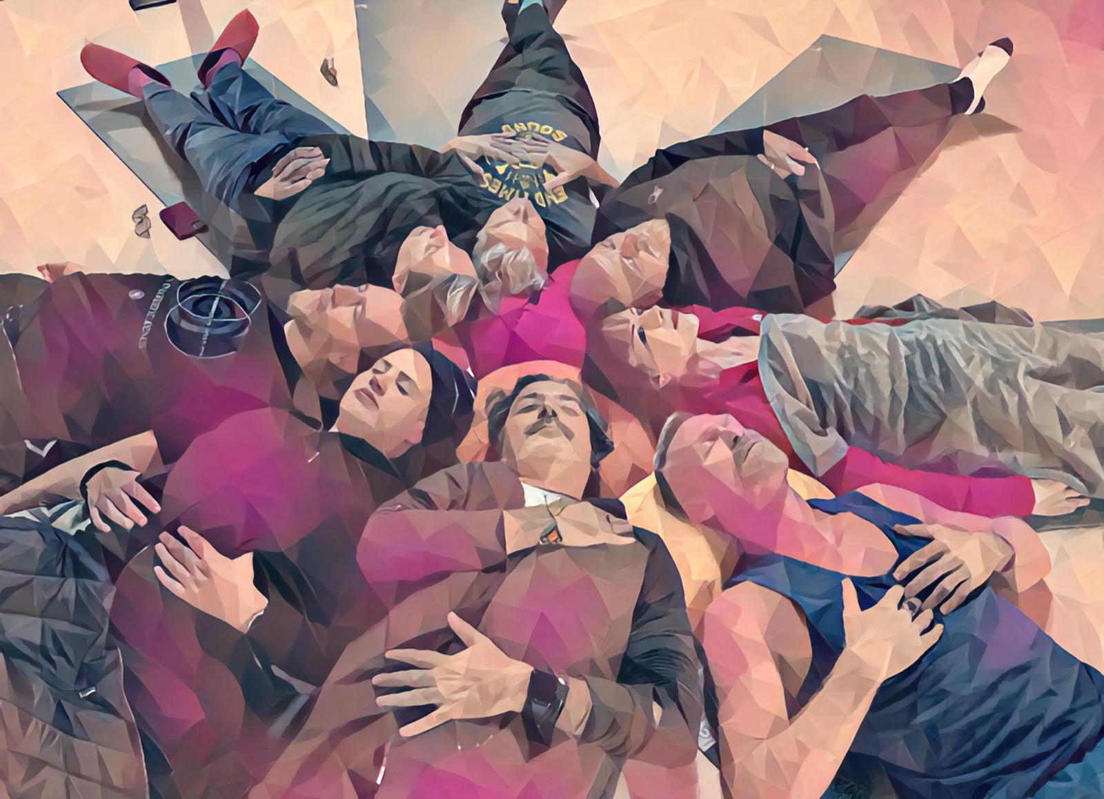 A group of guests lying in a circle with eyes closed during a Denver Zen Den group sound and light journey